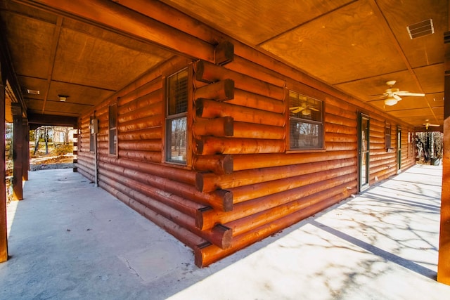 view of home's exterior featuring log siding and covered porch