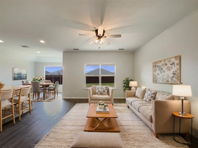 living room with recessed lighting, visible vents, baseboards, and dark wood-type flooring