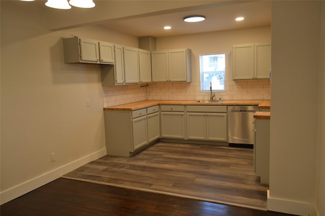 kitchen with a sink, backsplash, wood counters, and stainless steel dishwasher