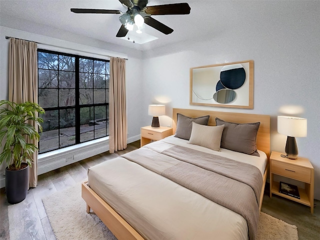 bedroom with wood finished floors and a ceiling fan