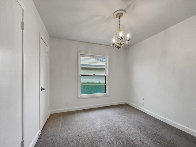 unfurnished bedroom with a chandelier, baseboards, and carpet