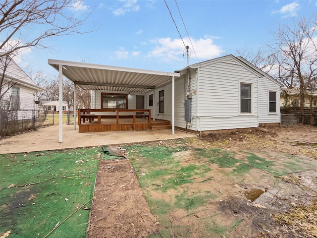 rear view of house featuring a patio area, a deck, and fence