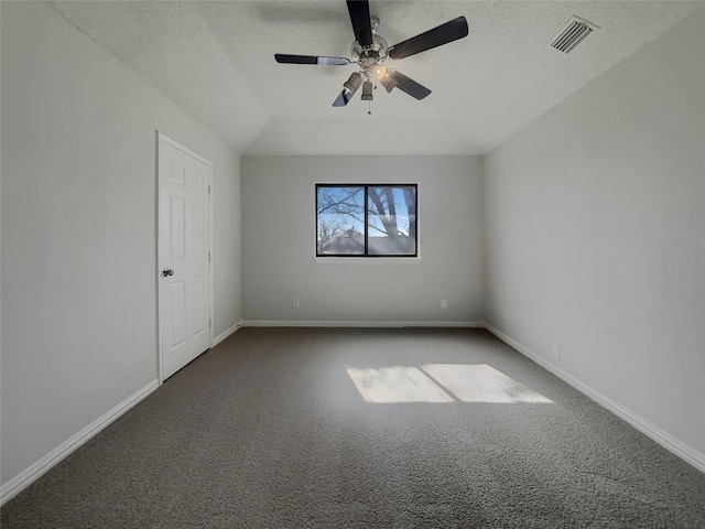 unfurnished room with visible vents, a textured ceiling, carpet flooring, baseboards, and ceiling fan