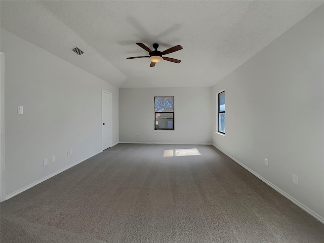 unfurnished room with visible vents, baseboards, a textured ceiling, a ceiling fan, and dark colored carpet