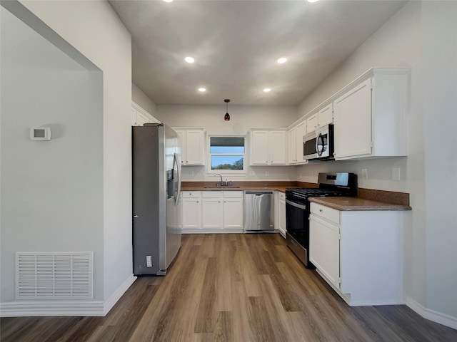 kitchen featuring white cabinetry, visible vents, appliances with stainless steel finishes, and a sink