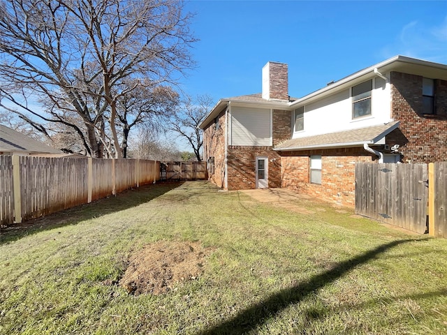 view of yard with a fenced backyard