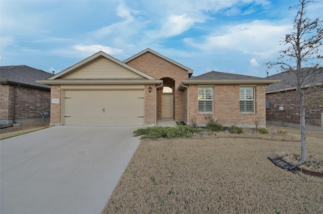 ranch-style house with an attached garage, brick siding, and driveway