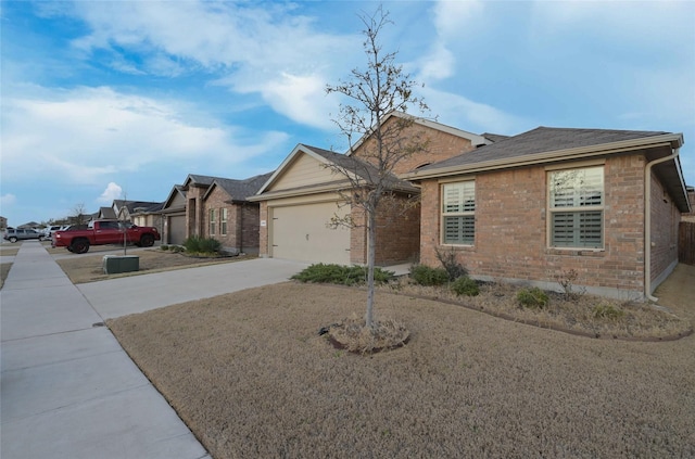 single story home featuring brick siding, concrete driveway, and a garage