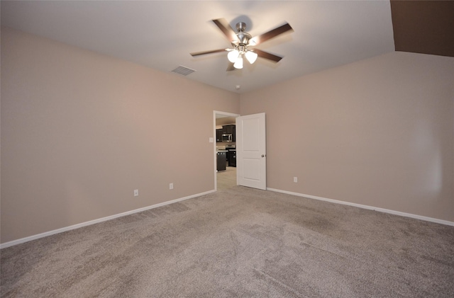 empty room featuring baseboards, a ceiling fan, visible vents, and light carpet