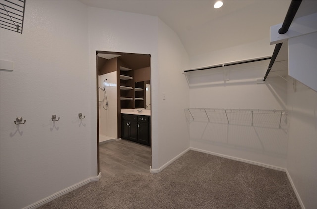 spacious closet with vaulted ceiling and carpet