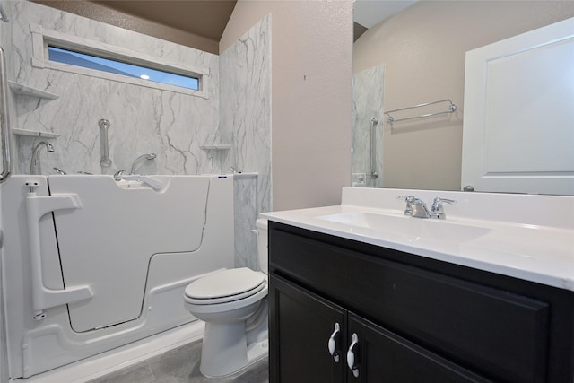 bathroom with vanity, toilet, and a bath