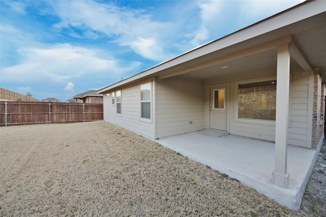 rear view of property with a patio area and fence