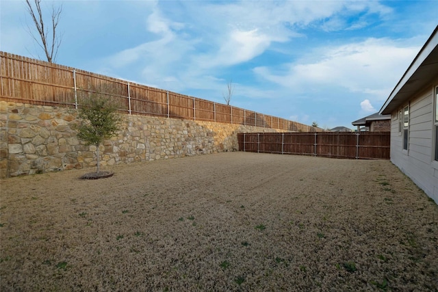 view of yard with a fenced backyard