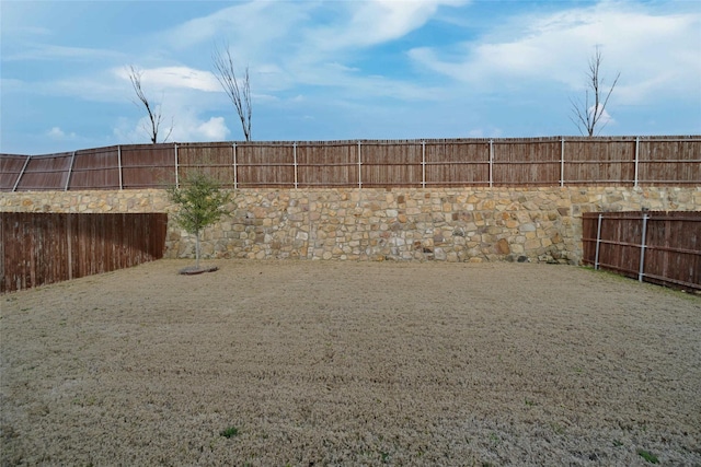 view of yard with a fenced backyard