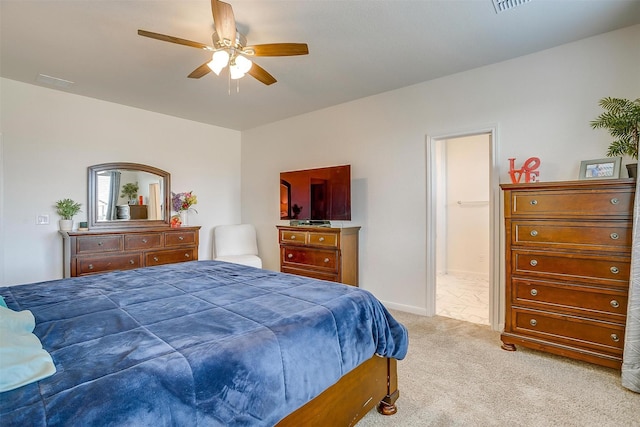 bedroom featuring visible vents, baseboards, carpet, ensuite bath, and a ceiling fan