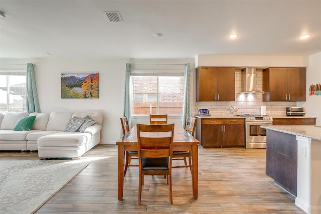 dining area with recessed lighting, light wood-type flooring, baseboards, and visible vents