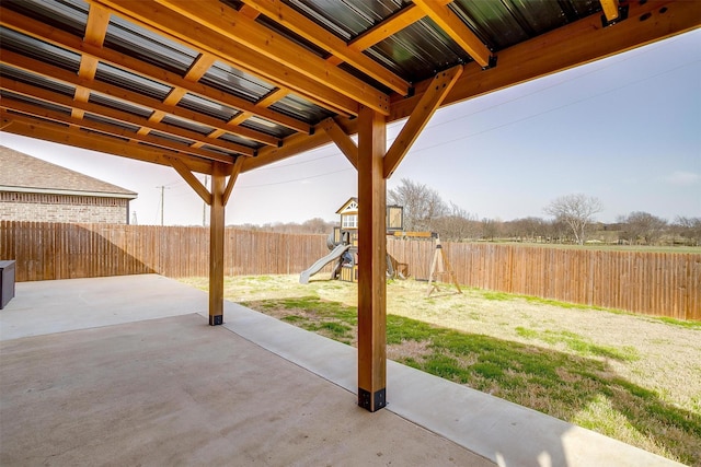 view of patio with a playground and a fenced backyard