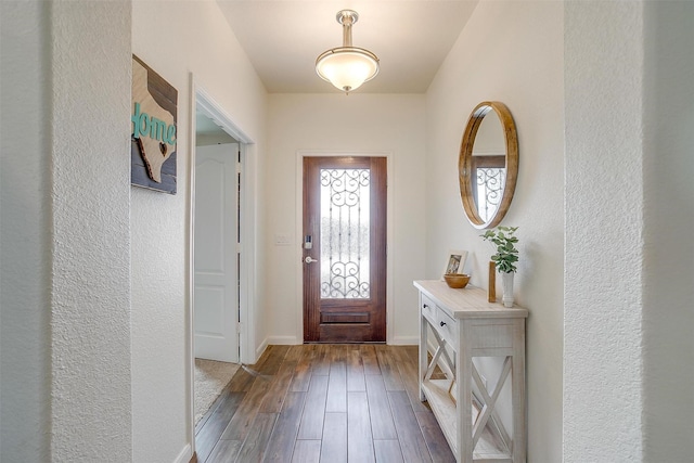 entrance foyer featuring baseboards and dark wood-style flooring