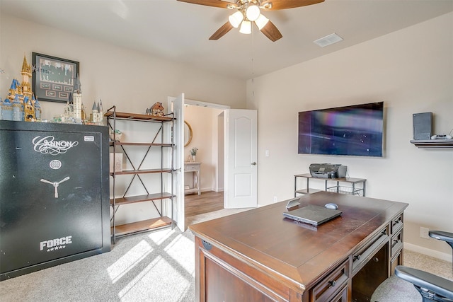 carpeted office space with visible vents, baseboards, and ceiling fan