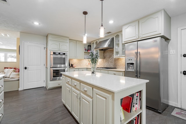 kitchen featuring open shelves, stainless steel appliances, wall chimney range hood, decorative backsplash, and hanging light fixtures