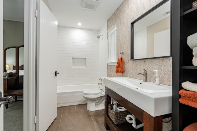 bathroom with vanity, shower / bathing tub combination, toilet, and visible vents