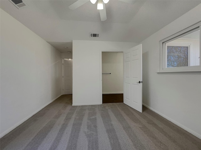 unfurnished bedroom with visible vents, ceiling fan, baseboards, and carpet floors