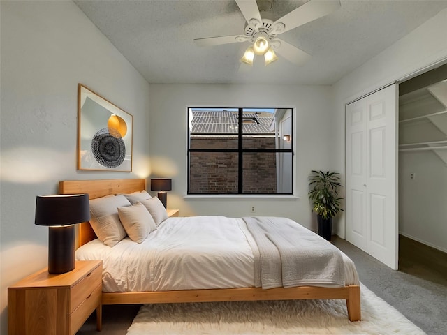 carpeted bedroom with a closet and ceiling fan