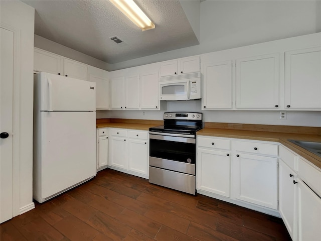 kitchen featuring dark wood finished floors, visible vents, white cabinets, and white appliances