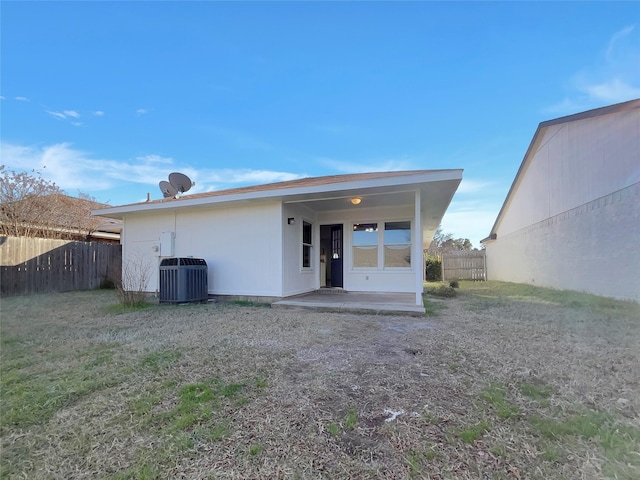 rear view of house featuring a patio, central AC, and fence