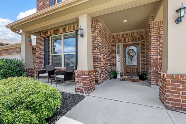 entrance to property with brick siding and covered porch