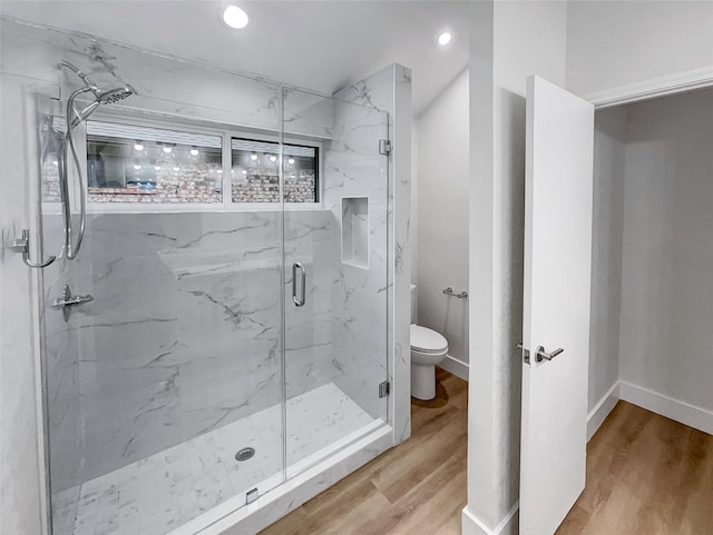 full bath with a marble finish shower, baseboards, toilet, recessed lighting, and wood finished floors