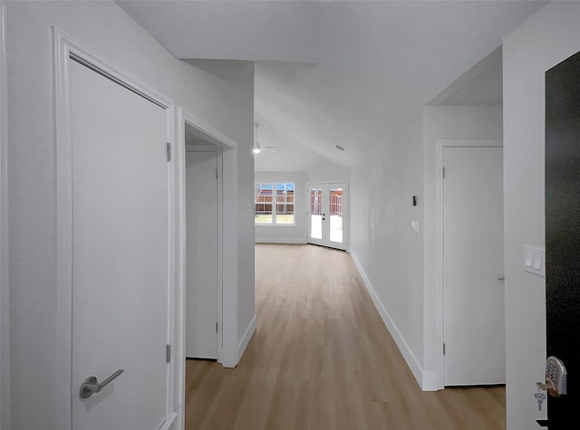 hall with baseboards and light wood-style flooring