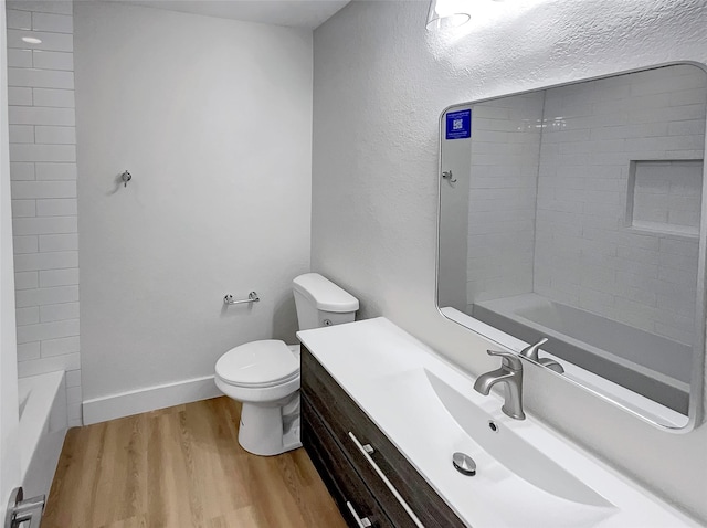 full bath featuring baseboards, toilet, wood finished floors, and vanity