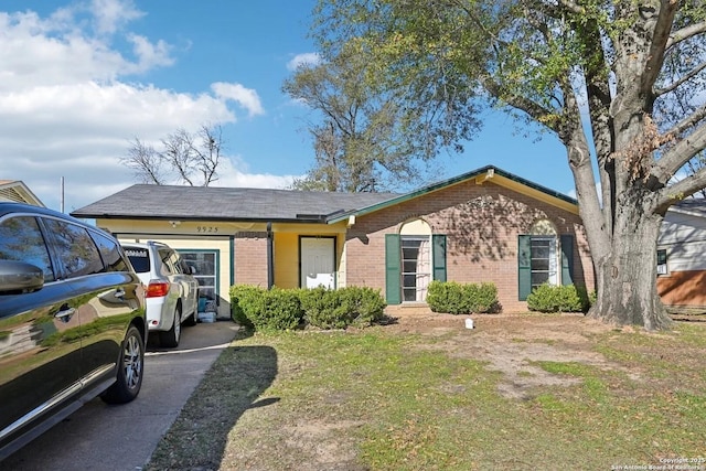 single story home featuring a garage and brick siding