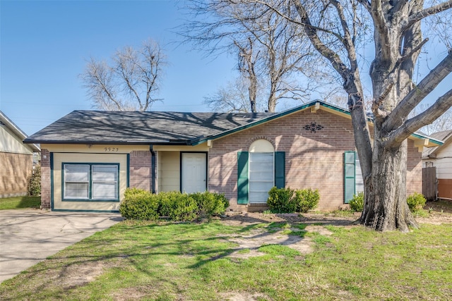 ranch-style home featuring a front yard, brick siding, and a shingled roof