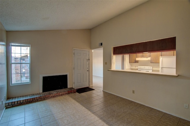 unfurnished living room featuring tile patterned flooring, visible vents, a brick fireplace, vaulted ceiling, and a textured ceiling