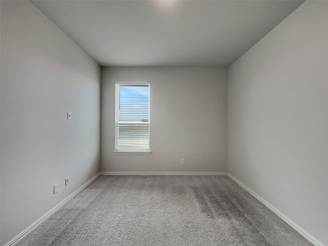 unfurnished room featuring baseboards and carpet floors