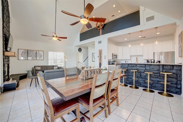 4880 Beach View Dr, Malakoff, TX 75148 - dining room featuring light tile patterned flooring, ceiling fan, visible vents, and high vaulted ceiling