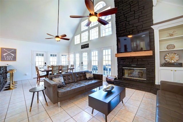 4880 Beach View Dr, Malakoff, TX 75148 - living area featuring a ceiling fan, high vaulted ceiling, a stone fireplace, and light tile patterned flooring