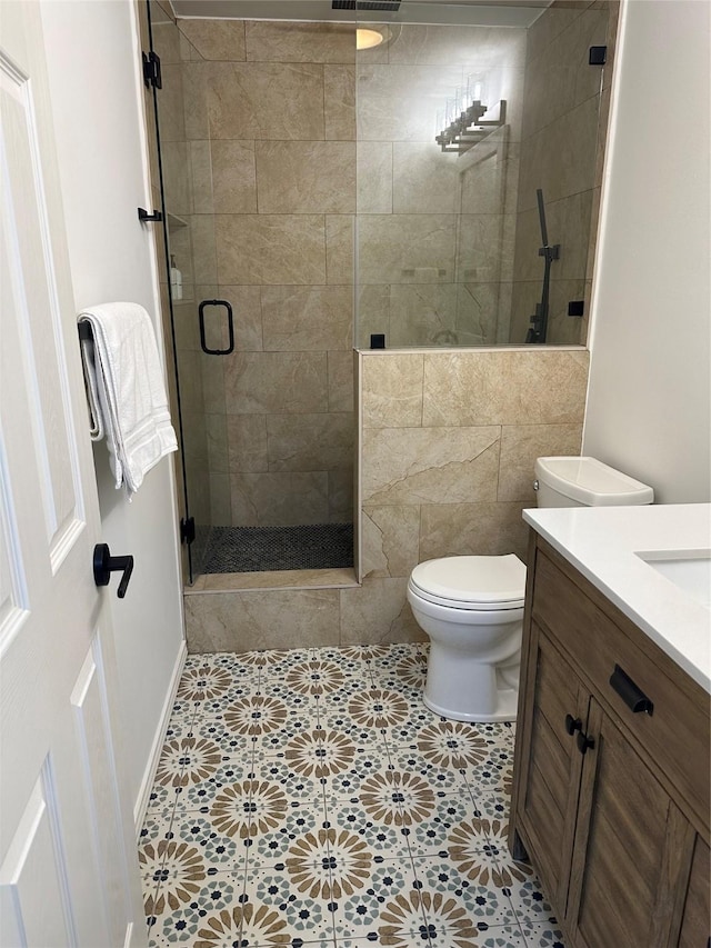 full bath featuring vanity, a shower stall, toilet, and visible vents