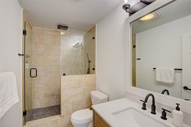 full bath with visible vents, toilet, a stall shower, and vanity