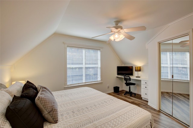 bedroom featuring ceiling fan, baseboards, lofted ceiling, and wood finished floors