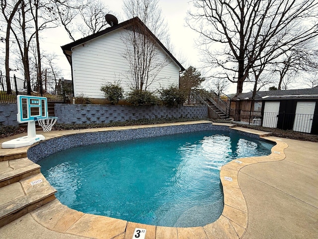 view of pool with a fenced in pool, a patio, stairs, and fence