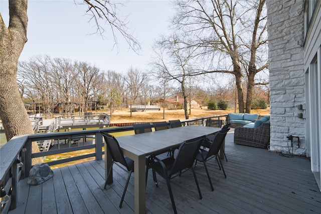 deck with outdoor dining area and an outdoor hangout area