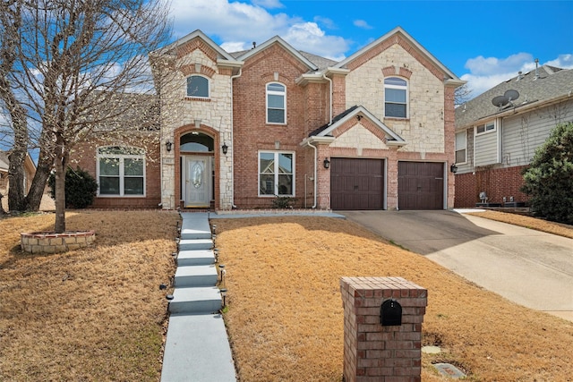 view of front facade with concrete driveway, a garage, brick siding, and stone siding