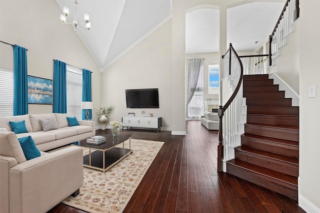 living area featuring baseboards, dark wood finished floors, stairs, an inviting chandelier, and high vaulted ceiling