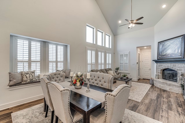 dining area with a healthy amount of sunlight, wood finished floors, and a fireplace