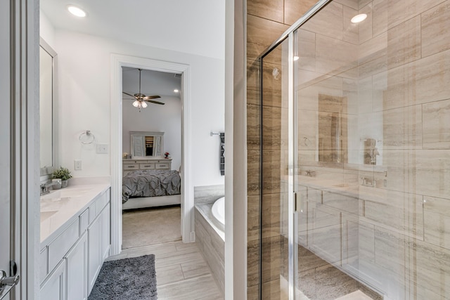 ensuite bathroom featuring ensuite bath, a shower stall, a bath, double vanity, and ceiling fan