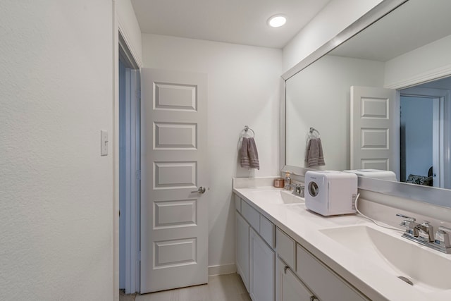 bathroom featuring double vanity and a sink