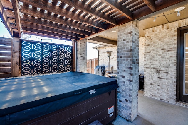 view of patio / terrace with a hot tub